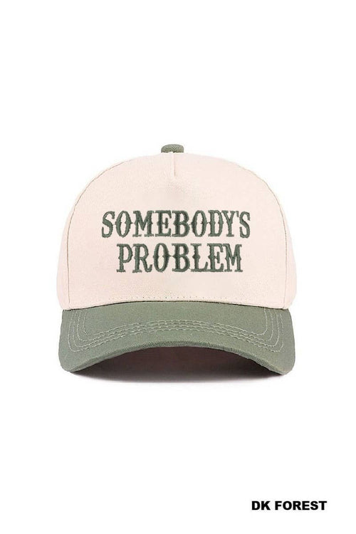 Cap with 'SOMEBODY'S PROBLEM' text on a white background