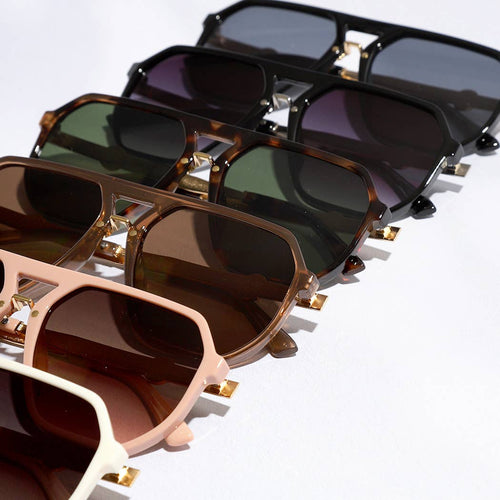 Collection of sunglasses with different frame colors on a white background