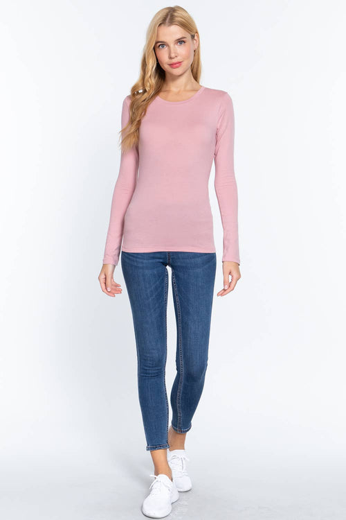 Woman wearing a pink sweater and blue jeans on a white background
