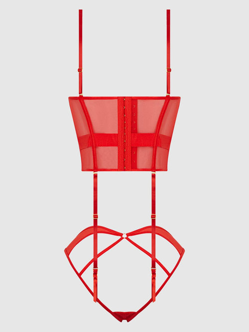 Red metal plant stand with geometric design on a white background