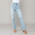 Light blue jeans worn by a person with a white background 