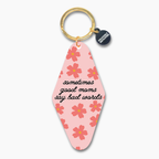 Keychain with floral design and text on a white background