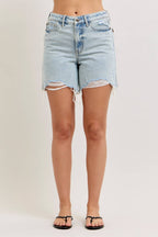 Light blue denim shorts with frayed hems on a plain background