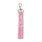 Pink leather key fob with floral tooling on a white background