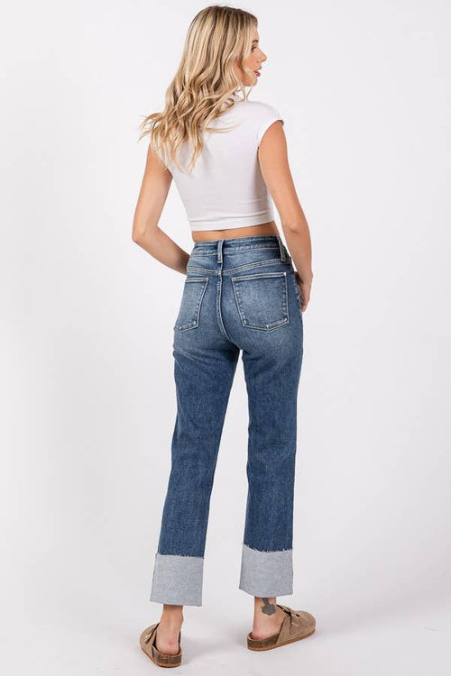 Woman wearing blue jeans with a white background