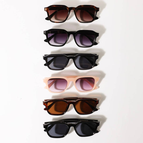 Set of six pairs of sunglasses in various colors arranged on a white background