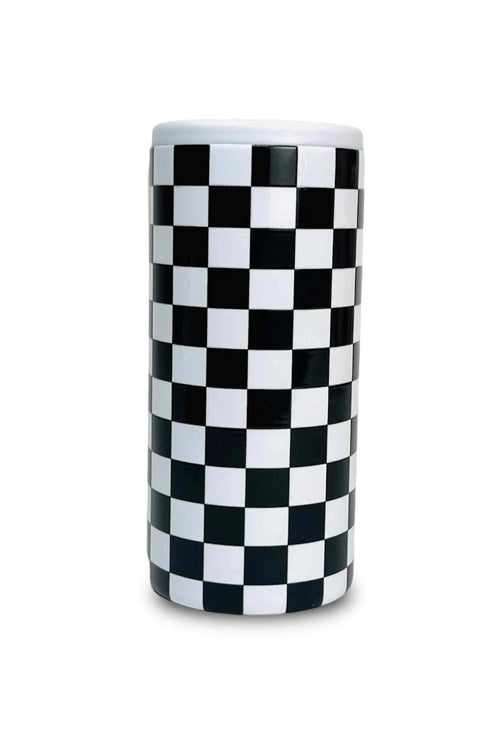 Checkered black and white cylindrical object on a white background