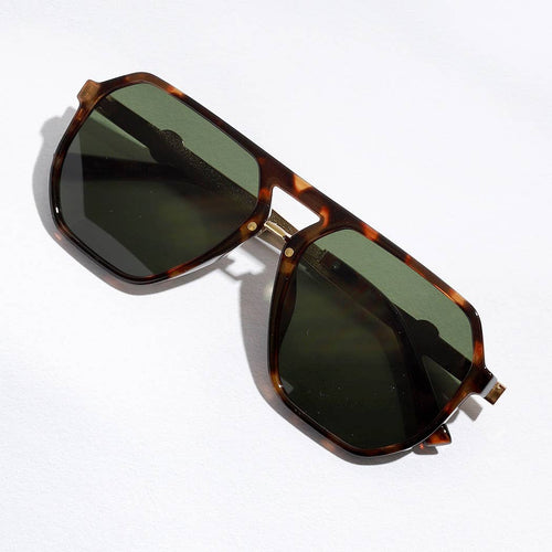 Sunglasses with tortoiseshell frame and dark lenses on a white background