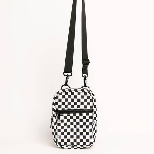 Black and white checkered crossbody bag on a light gray background