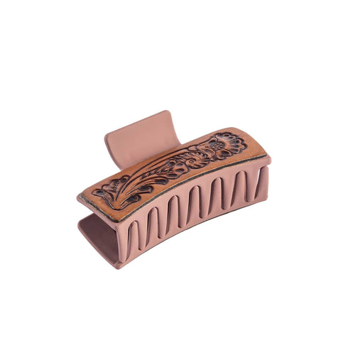 Decorative hair clip with intricate design on a white background