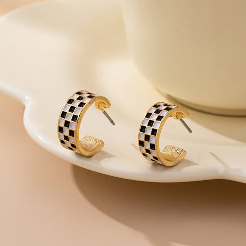 checkered huggie earrings on display table